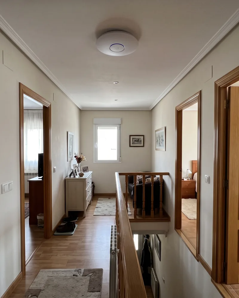 Punto de acceso WiFi de techo en el distribuidor de la planta alta de una vivienda, con cobertura para todos los dormitorios